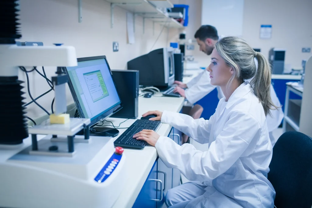 Scientist using a Laboratory Information Management System to automate lab workflows.